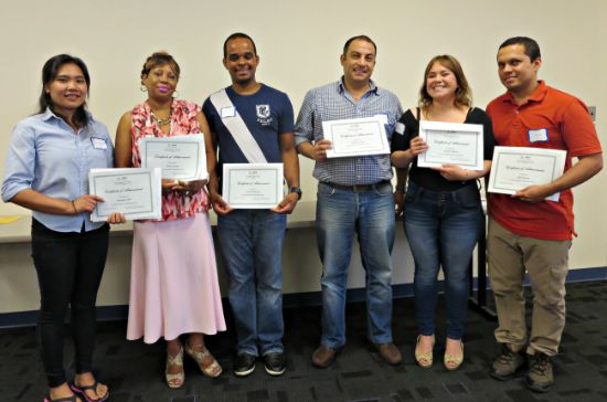 Proud GED students hold their certificates of achievement. Eighty-four students advanced at least one educational level last year.